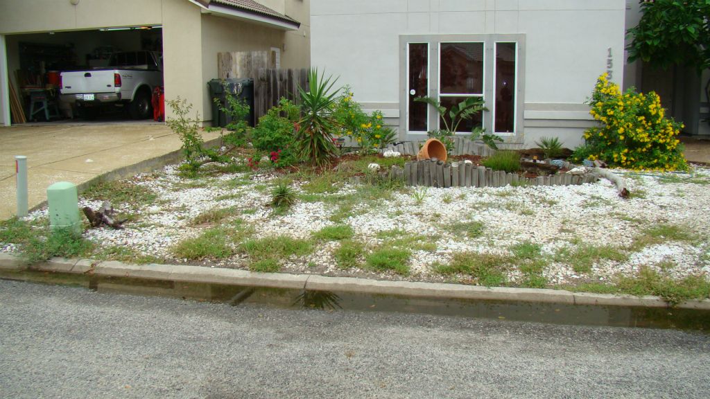 EXISTING PLANTS AND ROCK FRONT YARD TO BE REMOVED